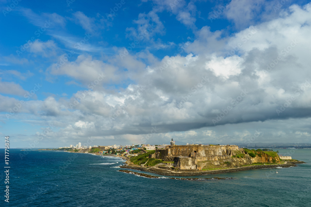 Scenic view of historic colorful Puerto Rico city in distance with fort in foreground