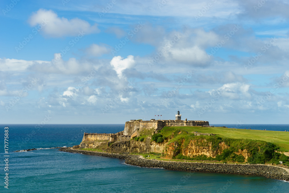 Scenic view of historic colorful Puerto Rico city in distance with fort in foreground