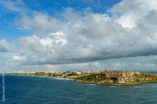 Scenic view of historic colorful Puerto Rico city in distance with fort in foreground