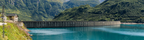 Dam panorama on mountain in sunny summer day outdoor.