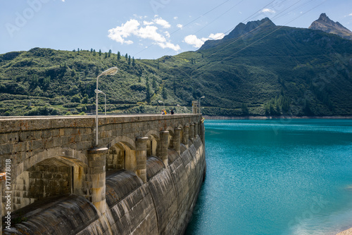 Dam wall detail on mountain in sunny summer day outdoor.
