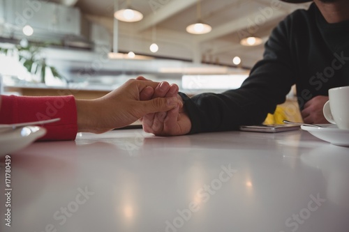 Cropped image of couple holding hands