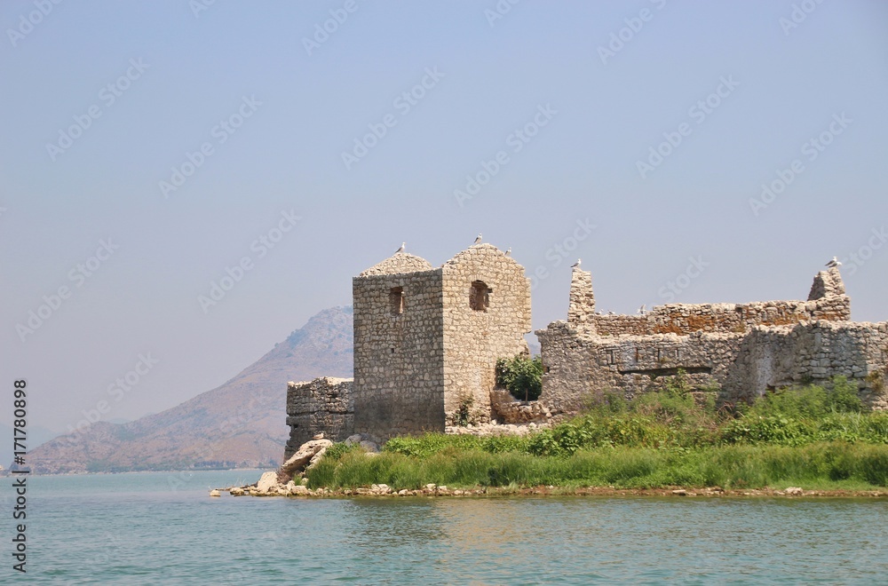 Lake Skadar in Montenegro and island Grmozur with the ruins of a fortress built by the Turks in 1843, also known as montenegrin Alcatraz. Southeast Europe.