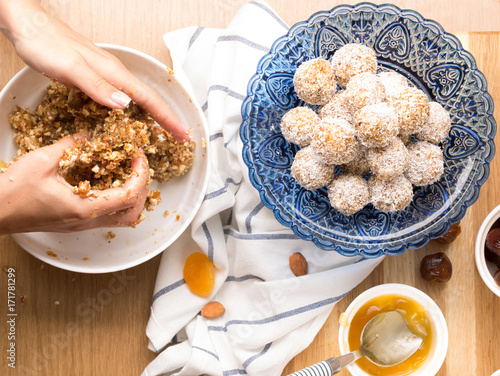 Cooking candy from dates, dried apricots and nuts, horizontal, selective focus, top view, hands in frame, ingredients