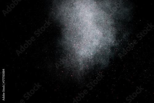 dust explosion on a black background for graphic resources. © fotobieshutterb