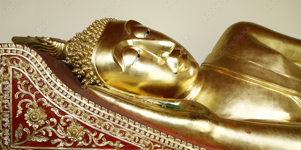 golden head of statue of buddha lay down