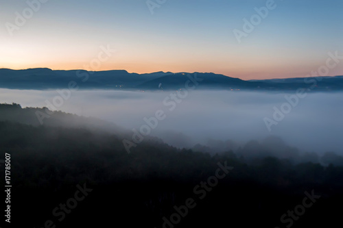 Beautiful view of misty sunrise in mountains