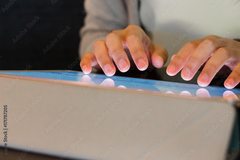 Person hand typing on tablet Person hand typing on tablet