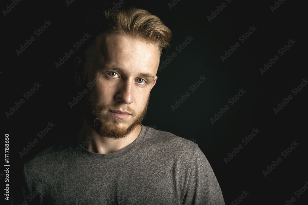 Obraz premium portrait of young man above black background