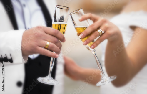 Bride and groom drinking champagne at the wedding