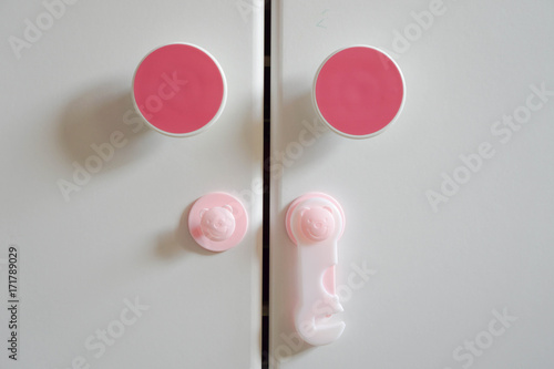 Wallpaper Mural Furniture safety lock for children, on unlock mode, pink color concept Torontodigital.ca