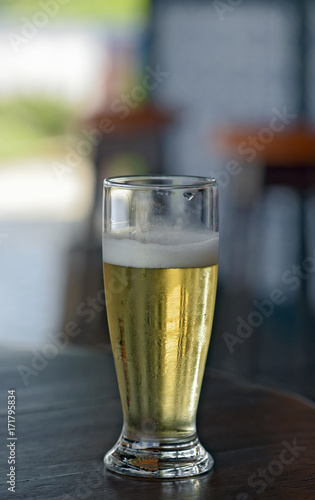 Glass of beer on a table of popular bar