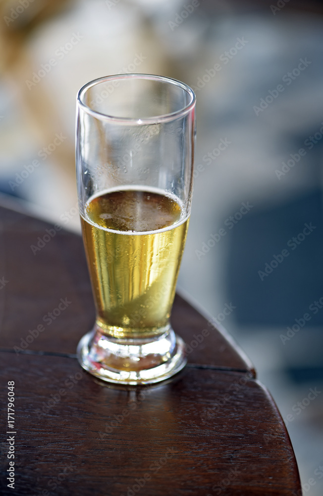Glass of beer on a table of popular bar Glass of beer on a table of popular bar