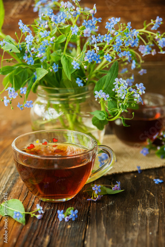 Two cups of tea and summer flowers