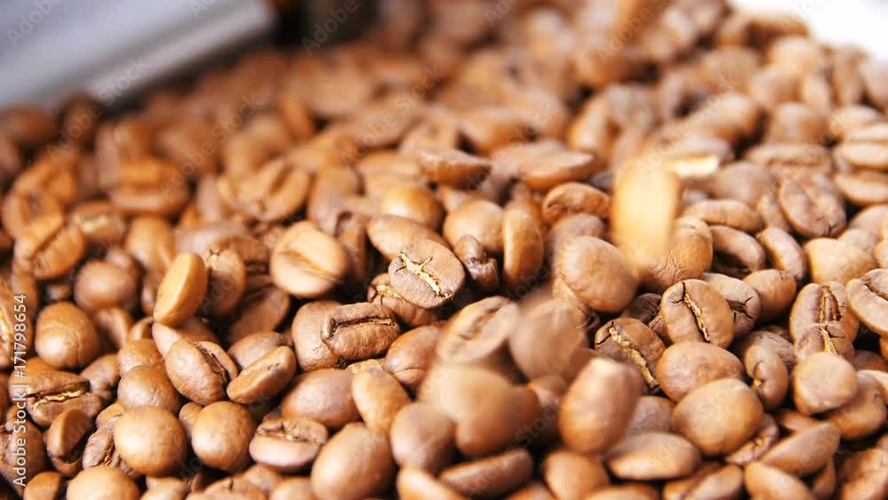 Macro Slow Motion Roasted Coffee Grains Fall into Box Macro Slow Motion Roasted Coffee Grains Fall into Box