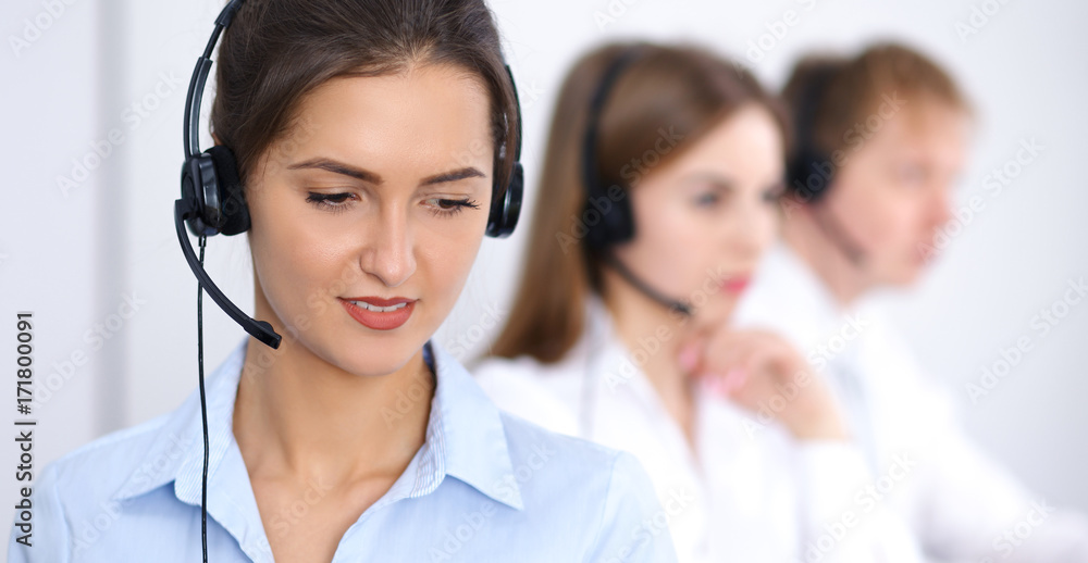 Call center. Focus on beautiful business woman in headset Call center. Focus on beautiful business woman in headset