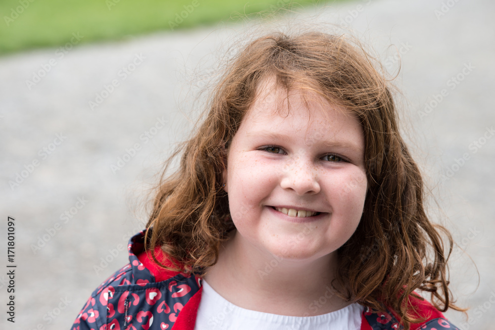 Young little girl portrait looking and smiling at the camera. Young little girl portrait looking and smiling at the camera.