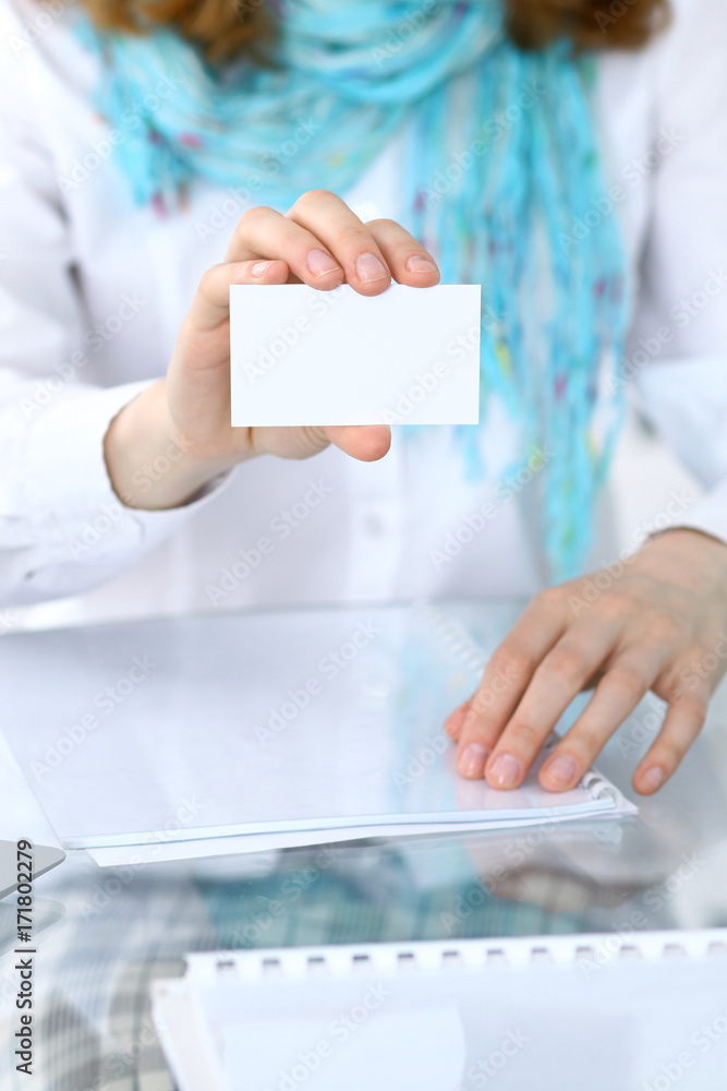 Close-up of business woman giving a visit card Close-up of business woman giving a visit card