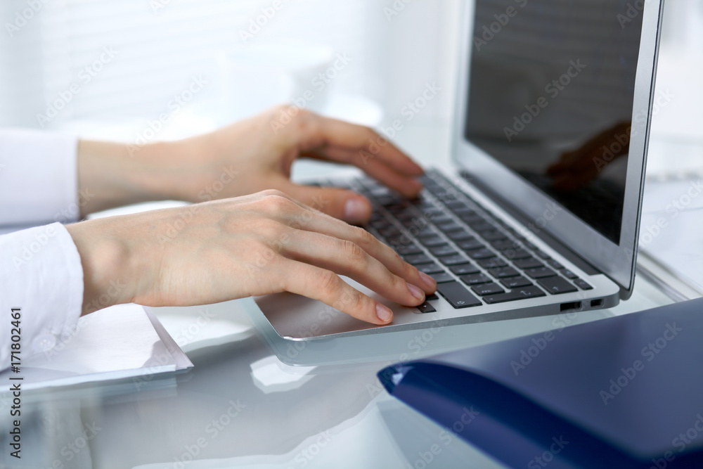 Close up of business woman hands typing on laptop computer Close up of business woman hands typing on laptop computer