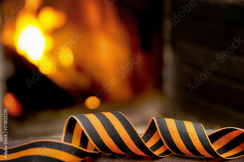 St. George's ribbon on a blurred fire background. 9th May