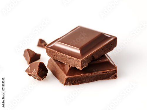 Macro photo  of Chocolate bar. Broken pieces over white background.