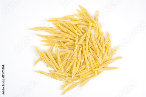 Dry pasta on white background, trofie.
