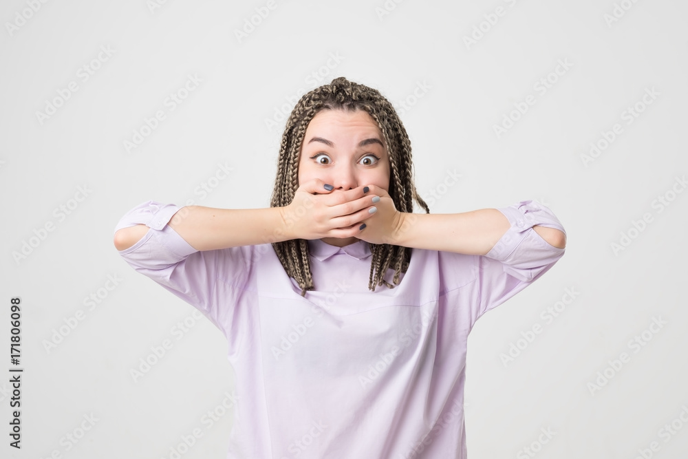 portrait of young woman shocked, isolated on a gray background portrait of young woman shocked, isolated on a gray background