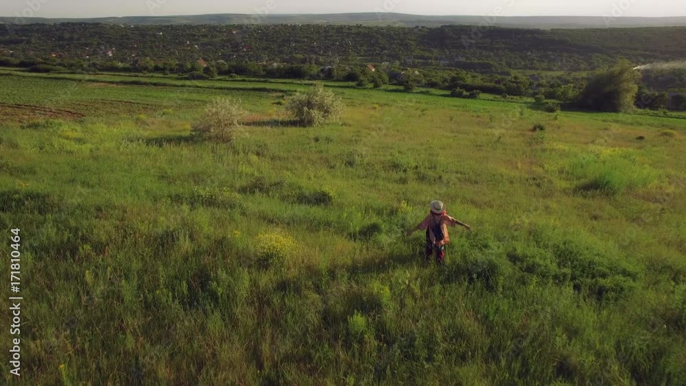 4K Aerial Above Village, Free Woman Walking with Hands Raised 4K Aerial Above Village, Free Woman Walking with Hands Raised