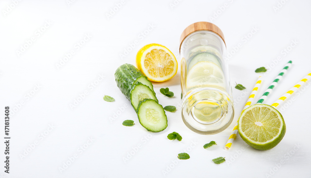 Detox Infused Water with Lemon, Lime,Cucumber and Mint in Sports Glass Bottle on a White Background.Healthy Beverage.Food diet concept.Vegetarian.Copy space for Text. selective focus. Detox Infused Water with Lemon, Lime,Cucumber and Mint in Sports Glass Bottle on a White Background.Healthy Beverage.Food diet concept.Vegetarian.Copy space for Text. selective focus.