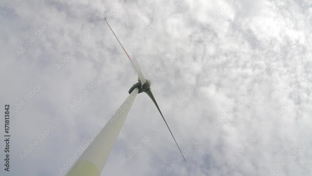 Wind turbine over stormy cloudy sky using renewable energy to generate electrical power. Renewable energy is most environmental way of power generation. Wind turbine over stormy cloudy sky using renewable energy to generate electrical power. Renewable energy is most environmental way of power generation.