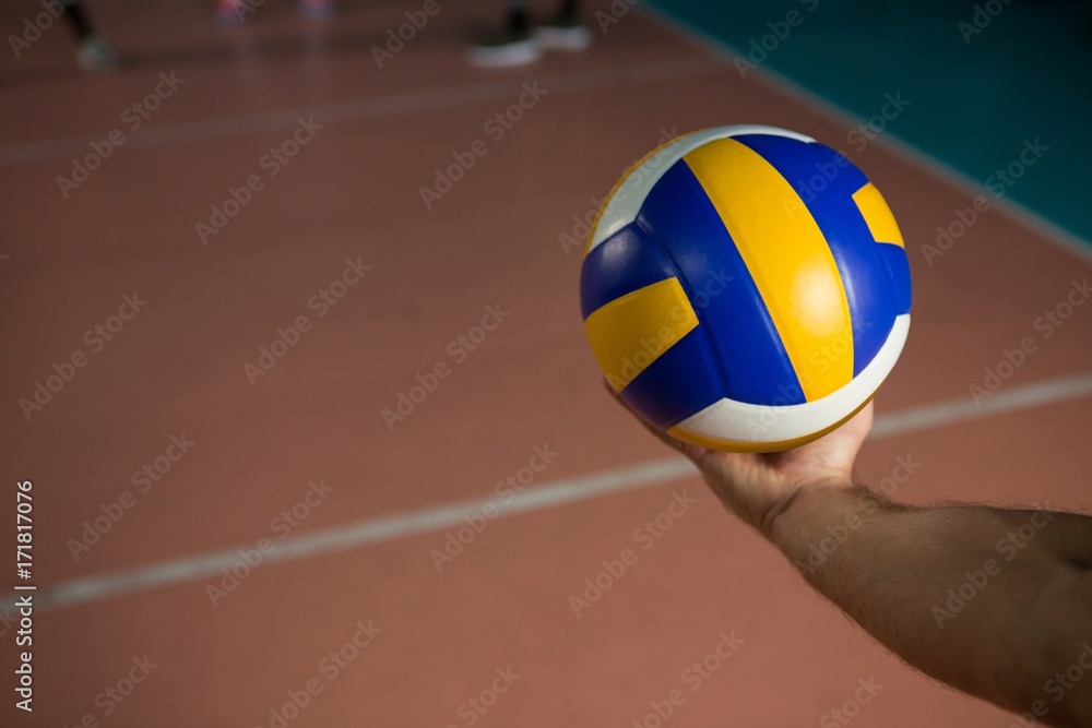 Cropped hand of sportsperson with volleyball