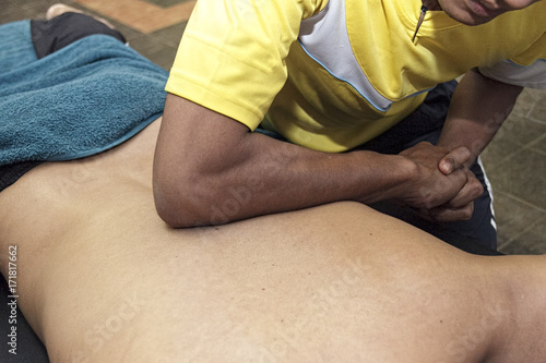 sport massage - men's hands are doing sport massage on the part of the human body
