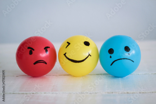 Three emotional ball in smiley happy face, mad face and sad face