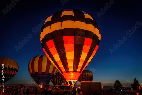 hot air balloons glowing in night sky