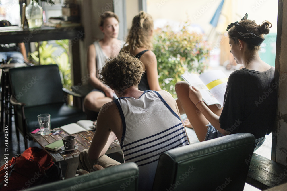 Group of caucasian people sitting relaxing in the hostel lobby Group of caucasian people sitting relaxing in the hostel lobby