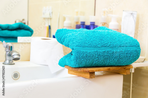 Blue towels on bathtub.