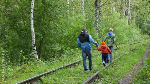 a teenage boy and his younger brother go with my father on the railroad tracks. Dangerous games and entertainment