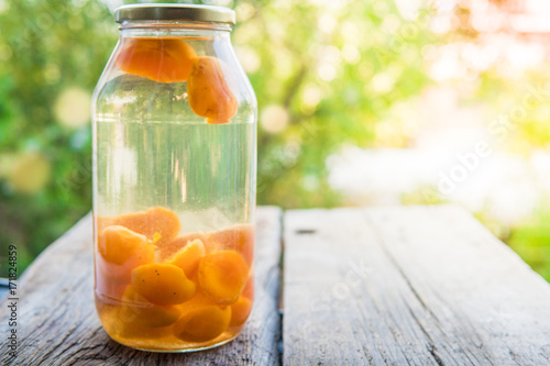 Apricot compote in a glass jar outdoor