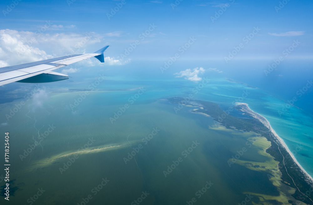 View of the paradise island in Caribbean Sea from window of airplane View of the paradise island in Caribbean Sea from window of airplane