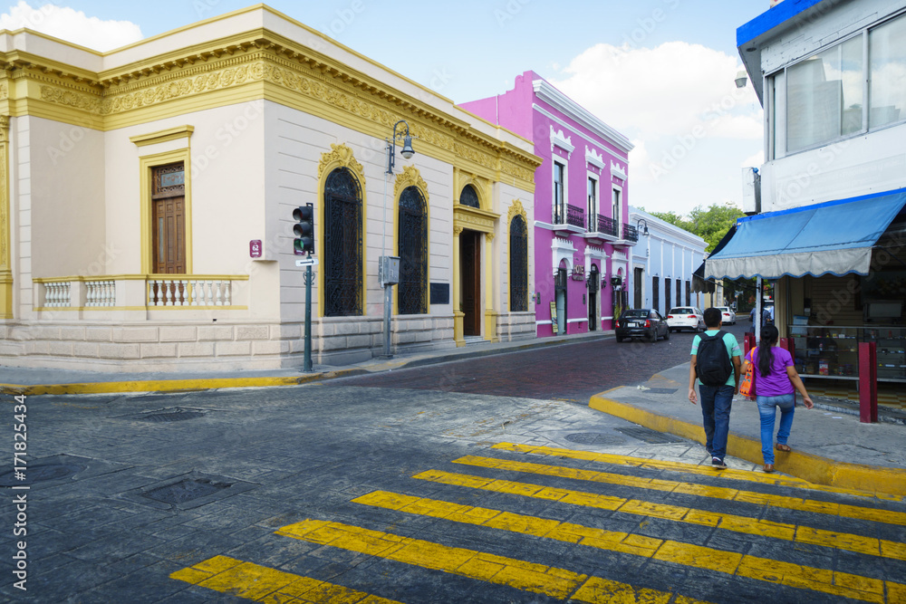 Narrow road near two colorful bright building on the street of Mexico