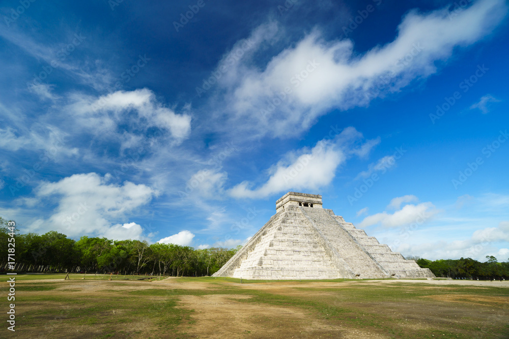 Maya pyramid temple of Kukulkan in Mexico. Ancient symbol of architecture at summer sunny cloudy day