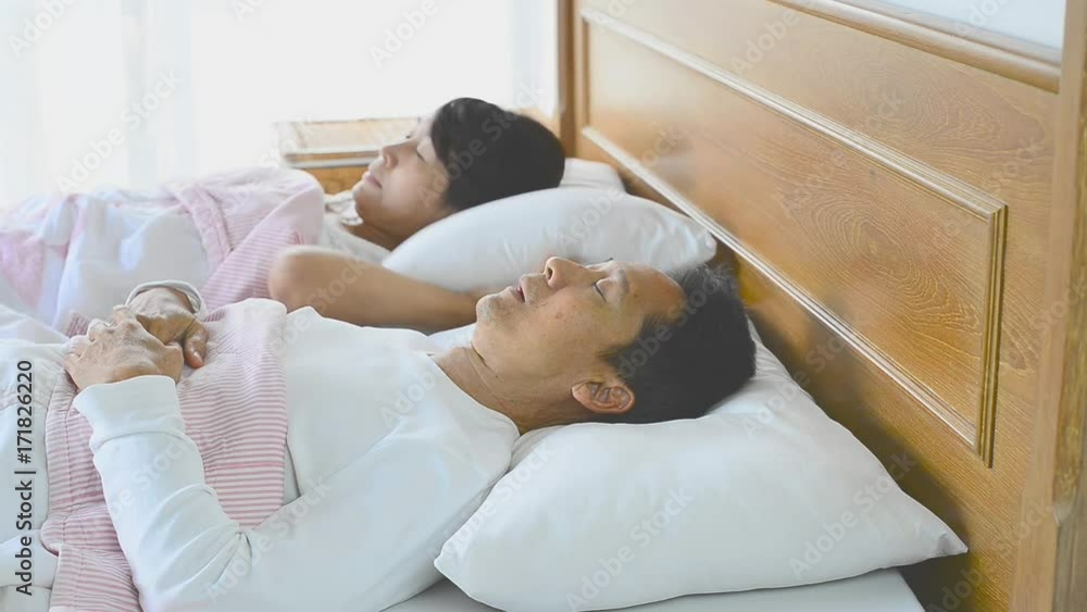 Sleep apnea man snoring and choking loud ,waking his wife up during the