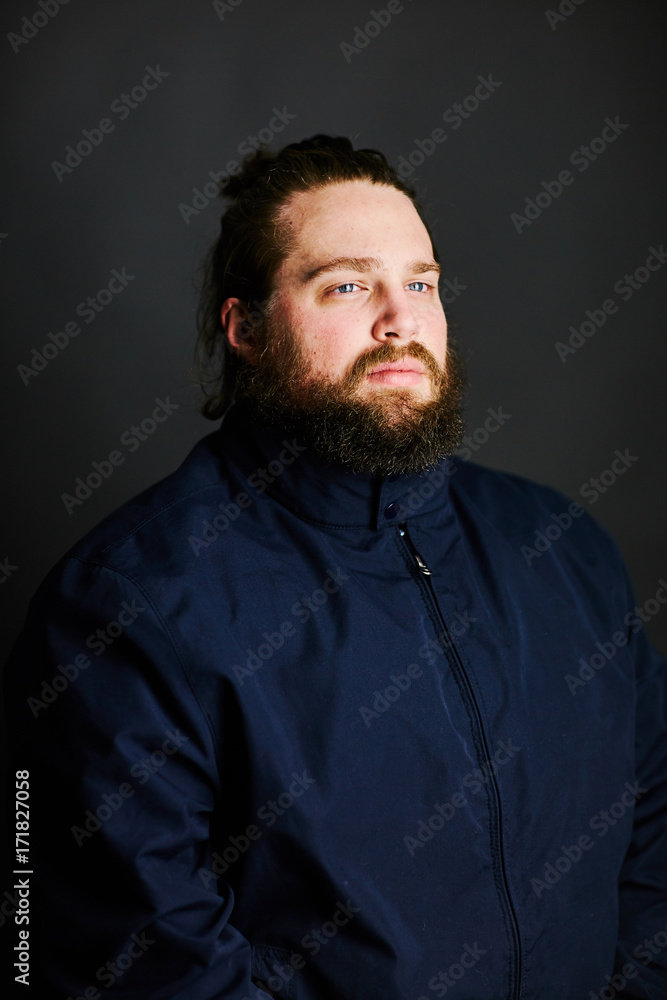 man with beard and long hair jacket zipped up ponytail serious face man with beard and long hair jacket zipped up ponytail serious face