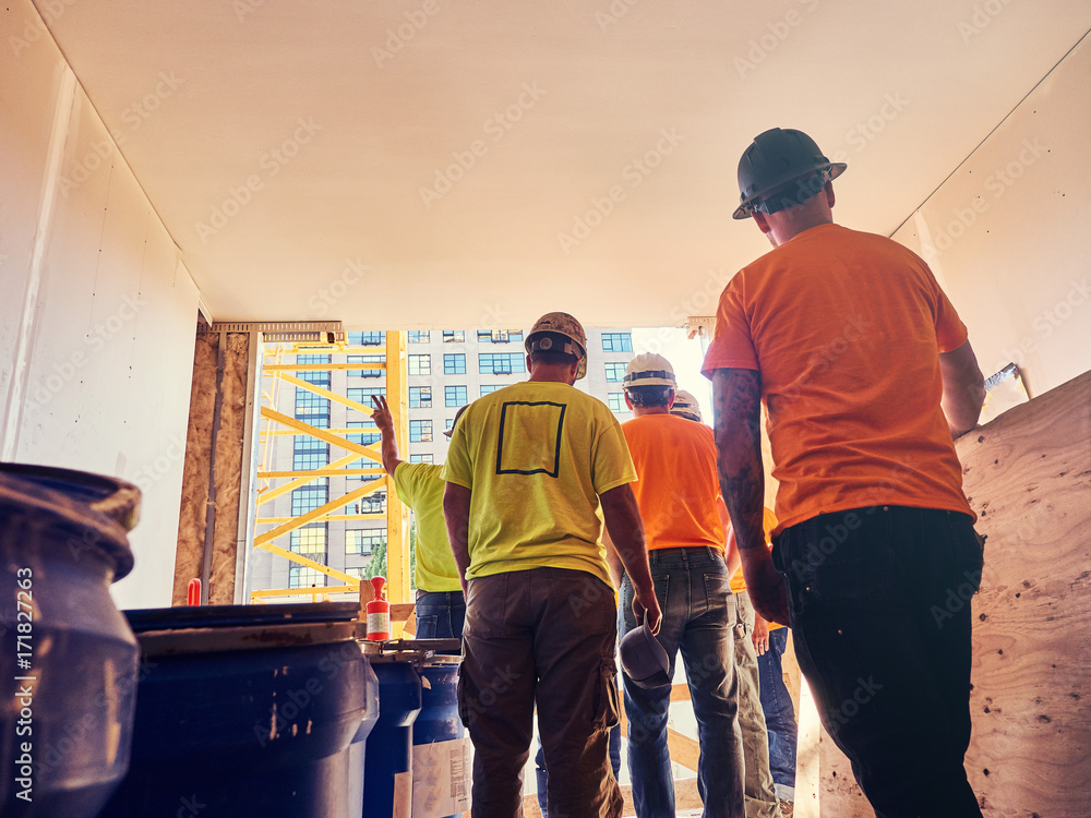 construction workers together at job site construction workers together at job site