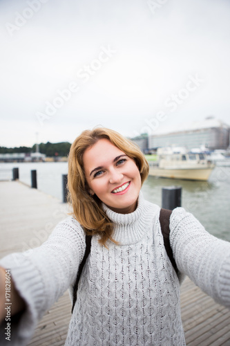A woman take selfie on a street in a European city