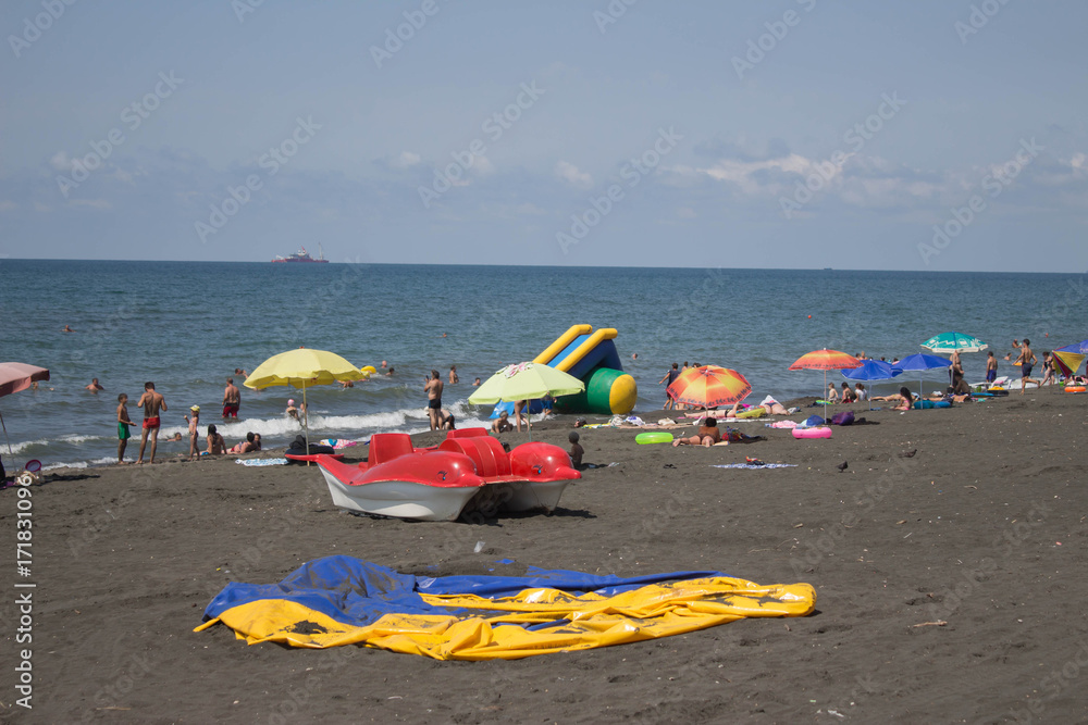 Blurred photo of people on sand beach, in sunshine day Blurred photo of people on sand beach, in sunshine day