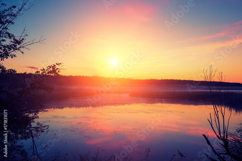 Early in the morning  sunrise over the lake. A misty morning  a rural landscape  a desert  a mystical feeling