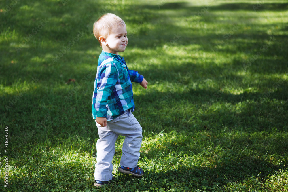 Little boy having fun playing in the Park on the grass Little boy having fun playing in the Park on the grass