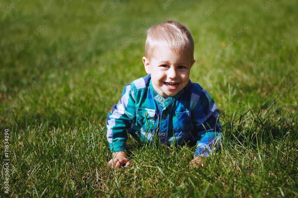Little boy having fun playing in the Park on the grass Little boy having fun playing in the Park on the grass