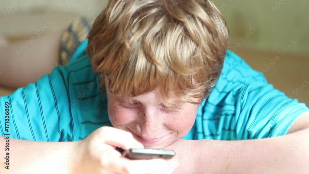Boy busy using smart phone, selective focus with shallow depth of field.
Boy busy using smart phone, selective focus with shallow depth of field.